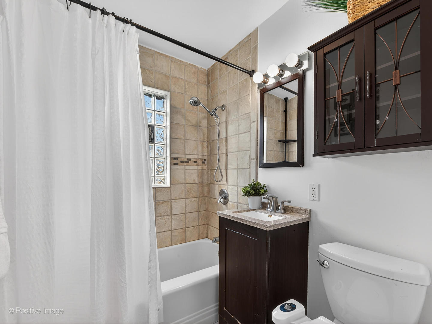 4214 Prairie Avenue Brookfield, IL 60513 - Photo 12 of 19 a bathroom with a sink a toilet and shower