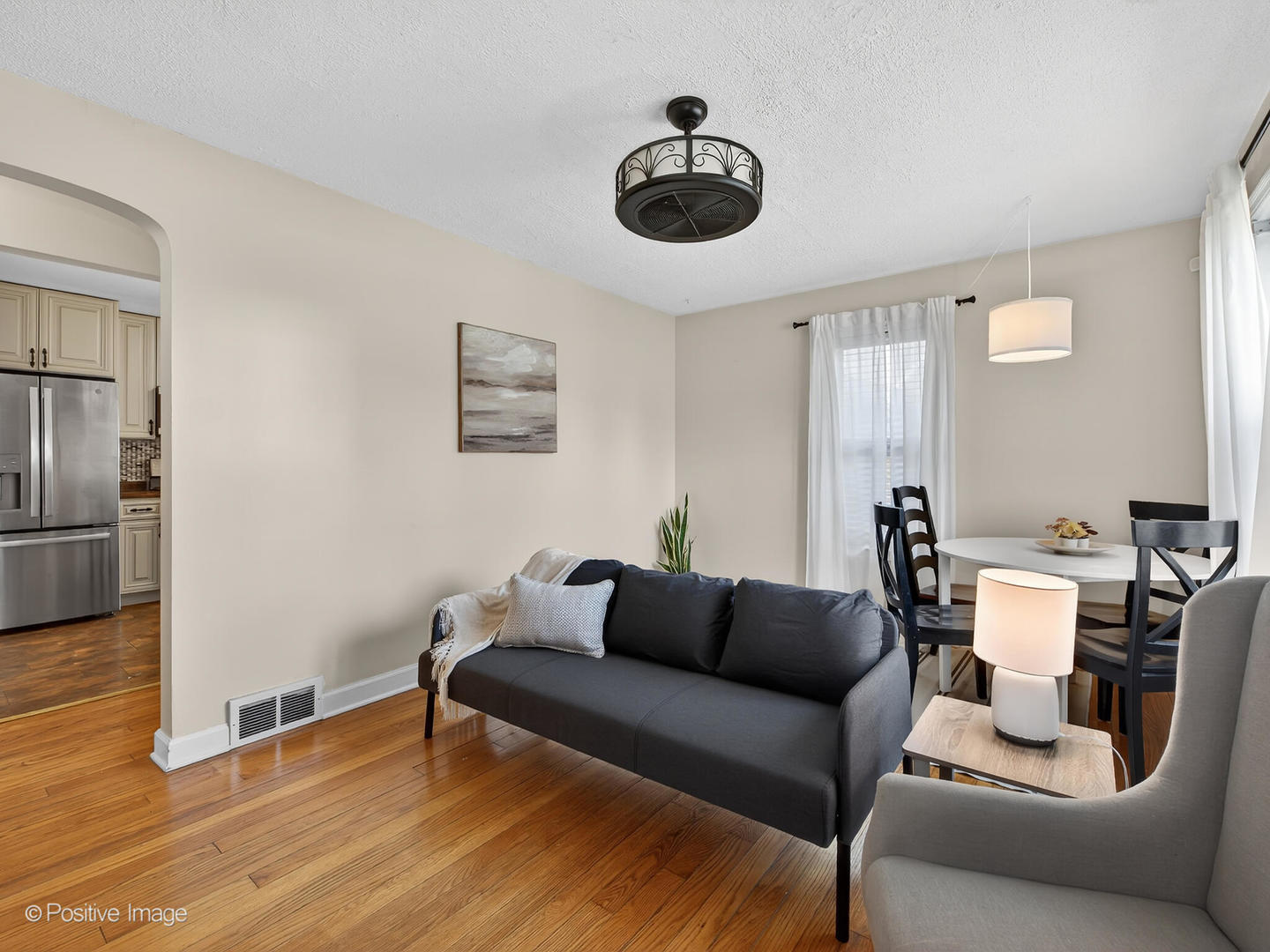 4214 Prairie Avenue Brookfield, IL 60513 - Photo 3 of 19 a living room with furniture a refrigerator and a table