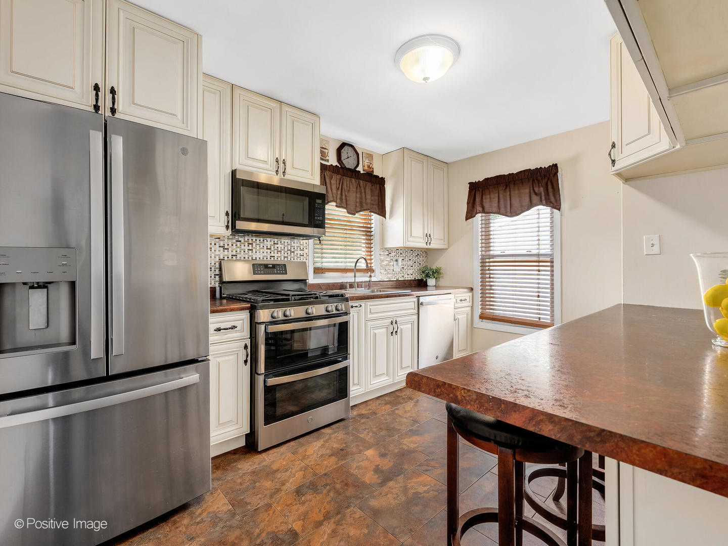 4214 Prairie Avenue Brookfield, IL 60513 - Photo 6 of 19 a kitchen with stainless steel appliances a stove refrigerator sink and cabinets