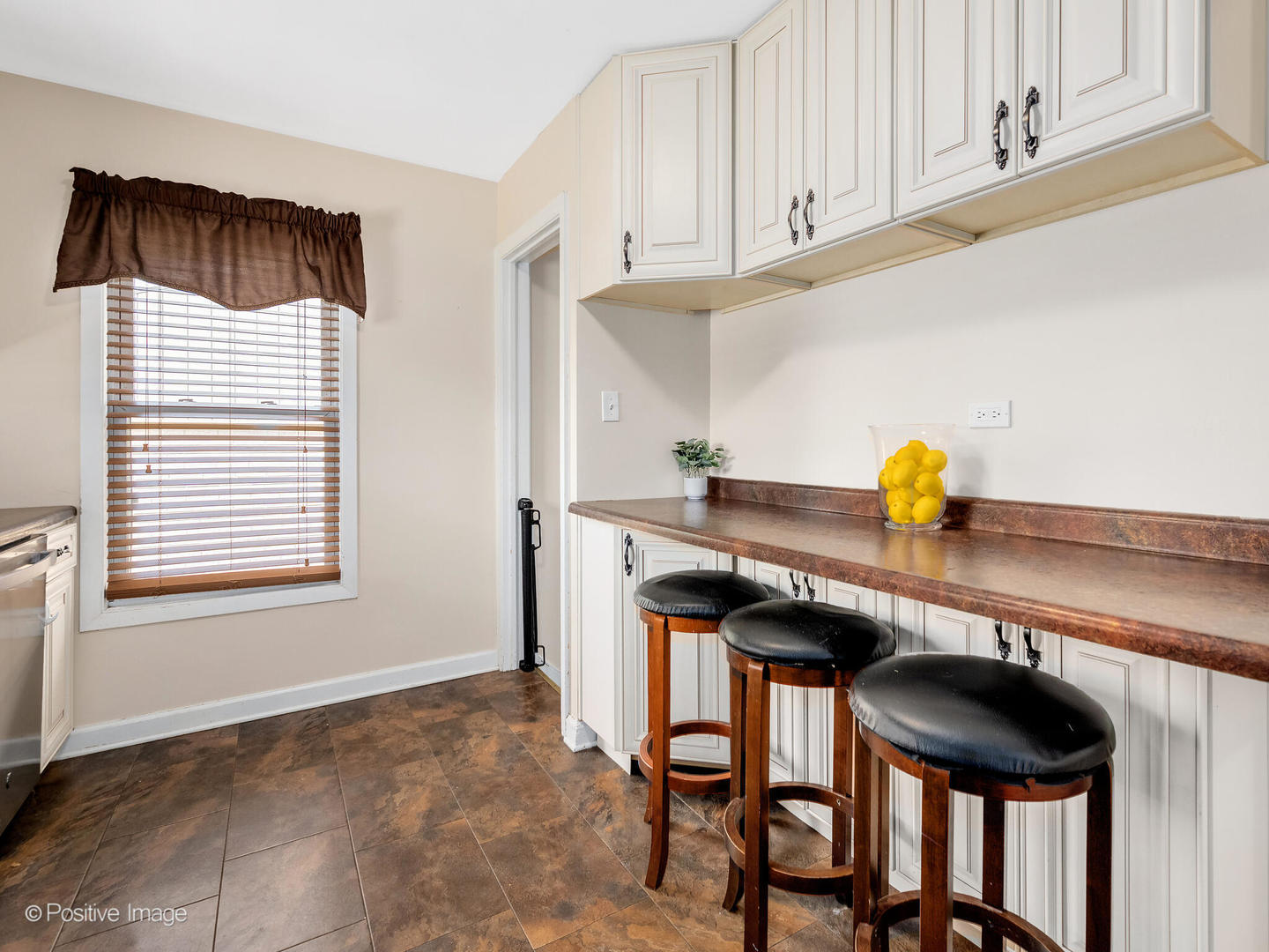 4214 Prairie Avenue Brookfield, IL 60513 - Photo 7 of 19 a kitchen with stainless steel appliances a table and chairs in it