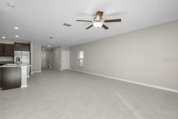 a view of a kitchen with a sink and stainless steel appliances