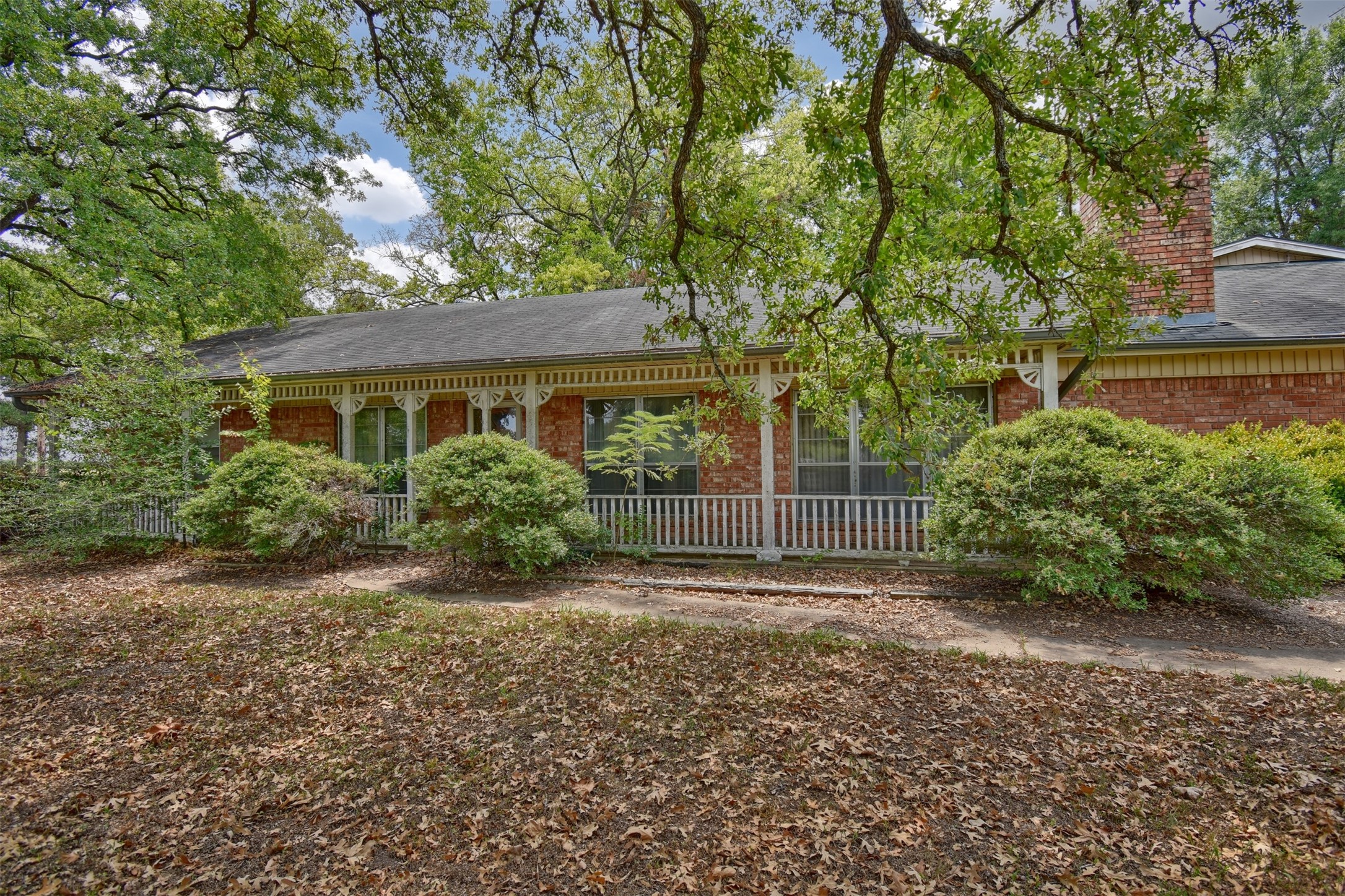 3775 Old Gay Hill Road Brenham, TX 77833 - Photo 3 of 13 a view of a house with a small yard and large tree