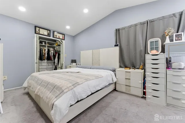 a bedroom with a bed and a dresser