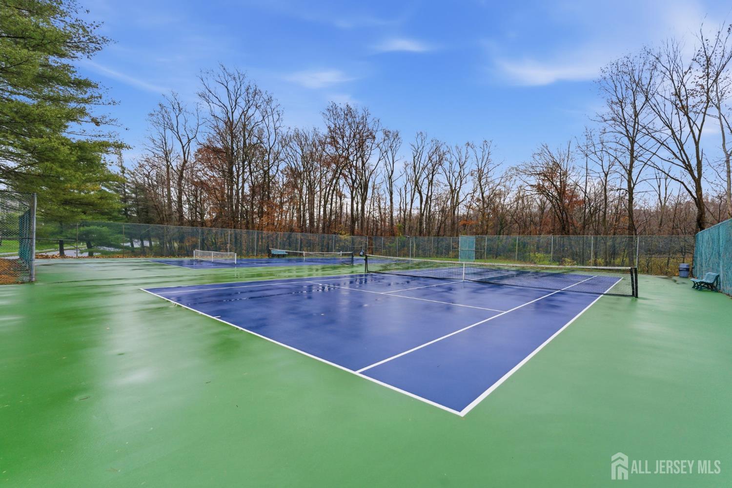 3242 Cypress Court Monmouth Junction, NJ 08852 - Photo 19 of 25 a tennis court that has trees in the background