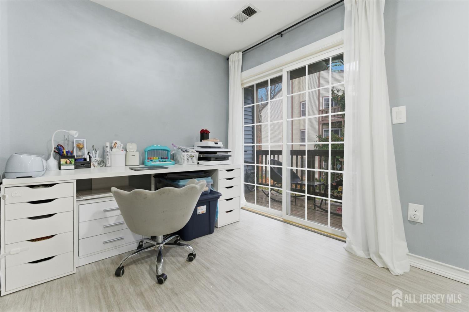 3242 Cypress Court Monmouth Junction, NJ 08852 - Photo 4 of 25 a view of a workspace with furniture and a window