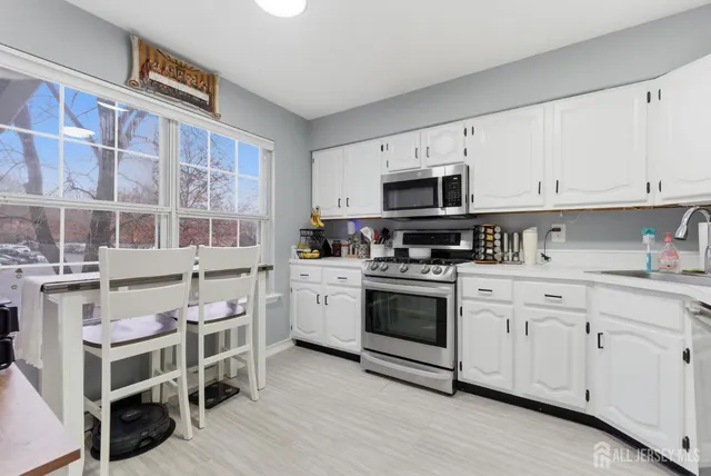 a kitchen with stainless steel appliances granite countertop a stove and cabinets