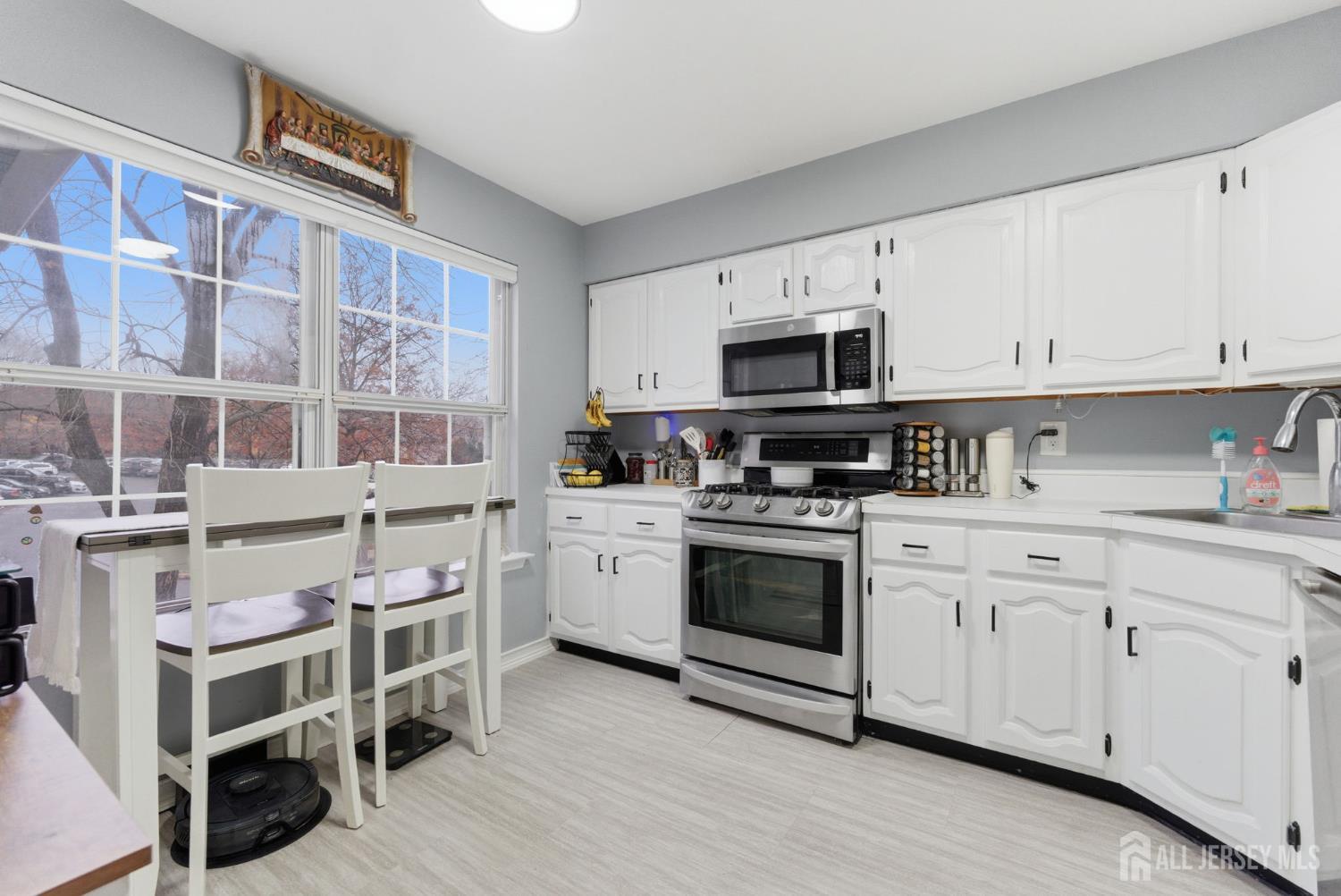 3242 Cypress Court Monmouth Junction, NJ 08852 - Photo 6 of 25 a kitchen with stainless steel appliances granite countertop a stove and cabinets