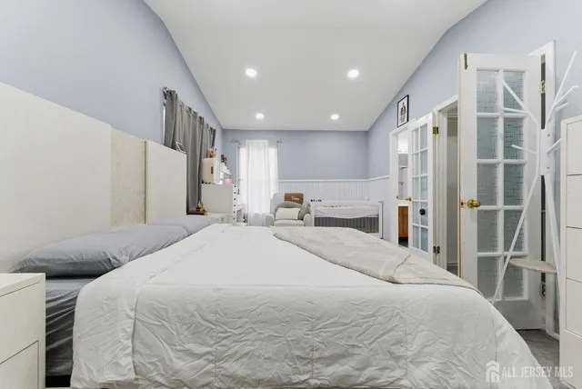 a spacious bedroom with a bed and a large mirror