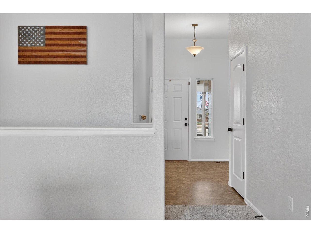 7545 McClellan Road Wellington, CO 80549 - Photo 23 of 42 Entrance foyer with fresh paint that leads to downstairs