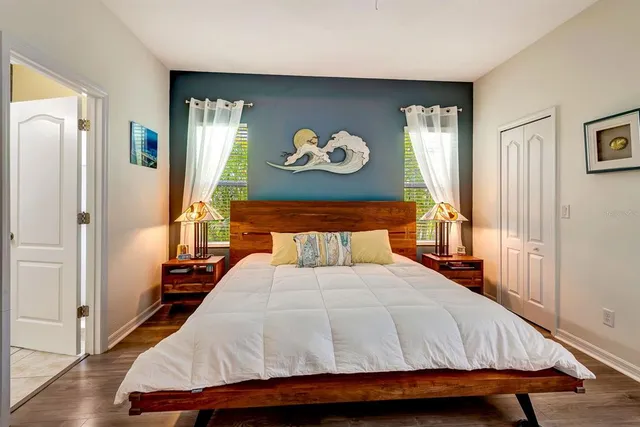 a bathroom with a granite countertop double vanity sink and a mirror