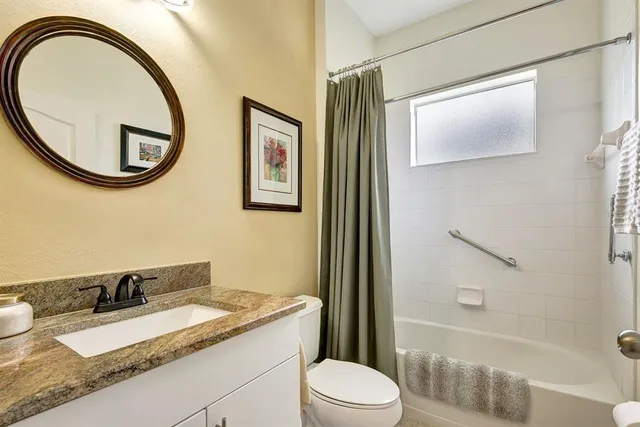 a room with a chair and flat screen tv