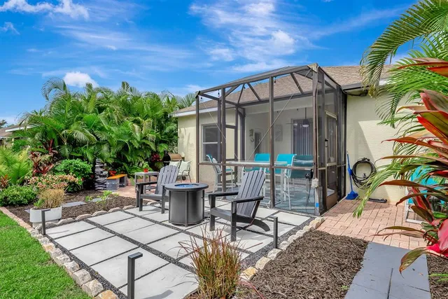 a view of a house with a yard and furniture