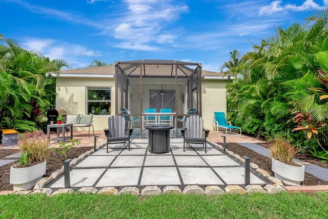 a view of a backyard with sitting area