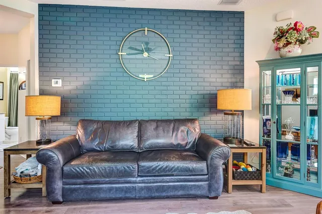a view of living room with furniture and a lamp