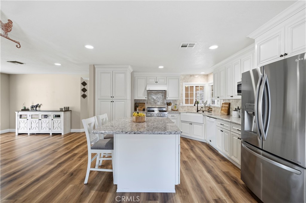 27816 Ridgegrove Drive Saugus, CA 91350 - Photo 15 of 65 a large kitchen with stainless steel appliances lots of counter space and a refrigerator