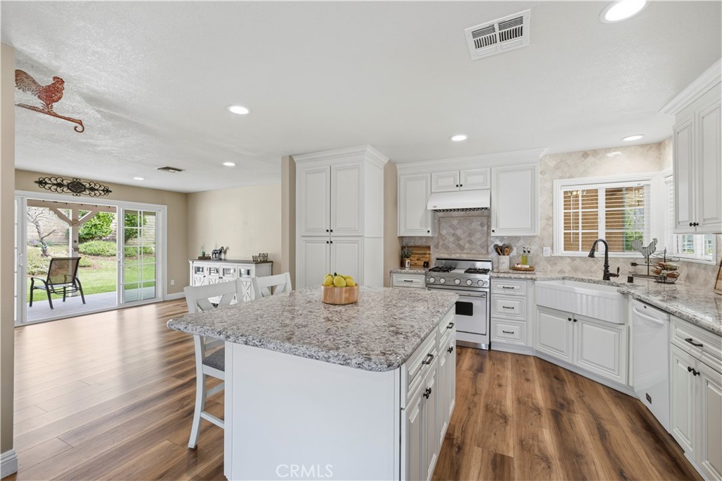 27816 Ridgegrove Drive Saugus, CA 91350 - Photo 19 of 65 a large kitchen with kitchen island a large counter top space a sink stainless steel appliances and cabinets