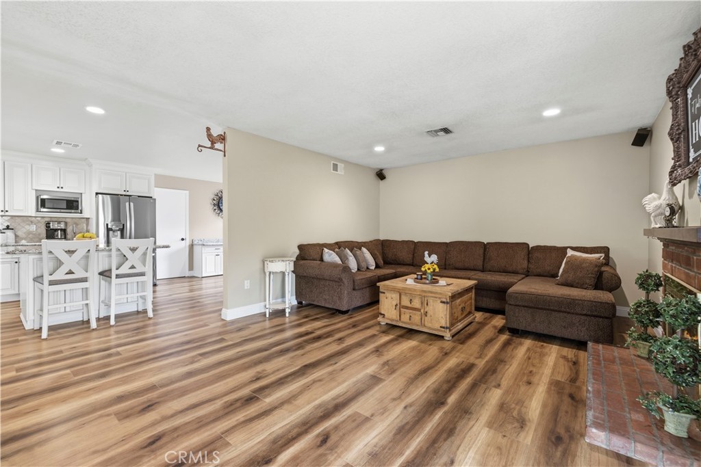 27816 Ridgegrove Drive Saugus, CA 91350 - Photo 23 of 65 a living room with furniture and kitchen view with wooden floor