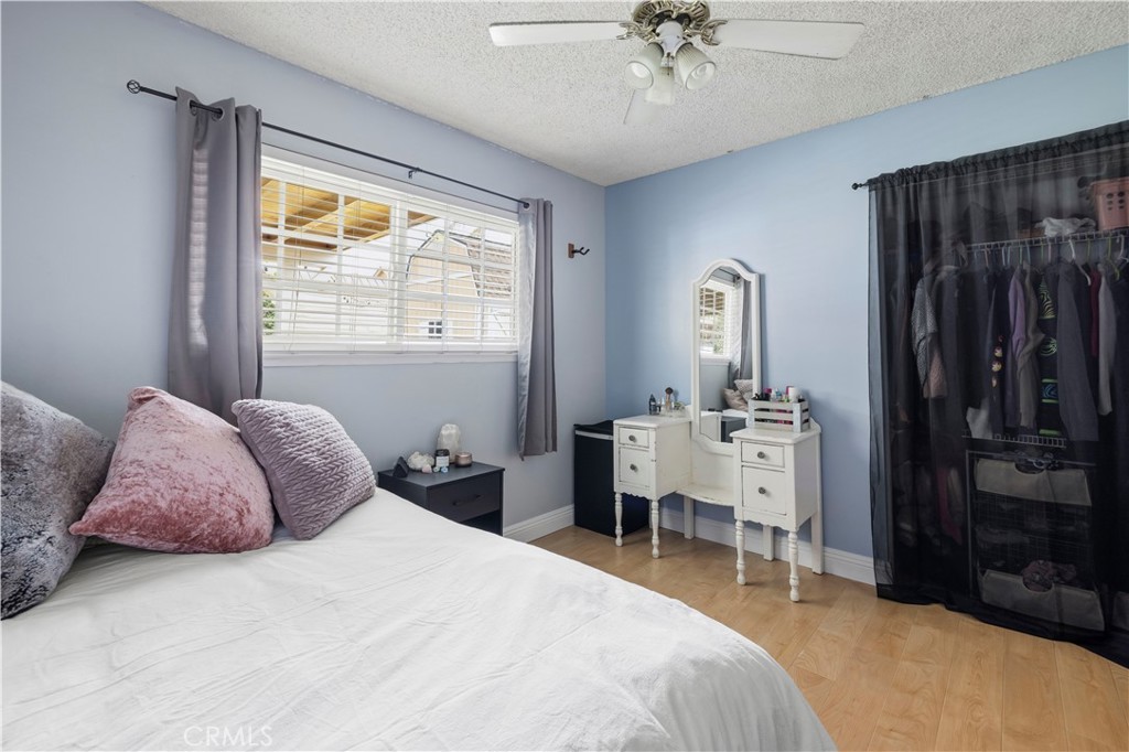 27816 Ridgegrove Drive Saugus, CA 91350 - Photo 29 of 65 a bedroom with a bed and a chandelier