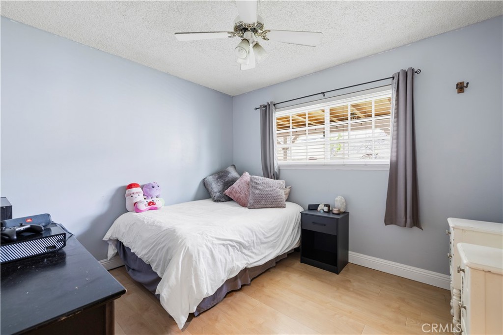 27816 Ridgegrove Drive Saugus, CA 91350 - Photo 30 of 65 a bedroom with a bed and a chandelier