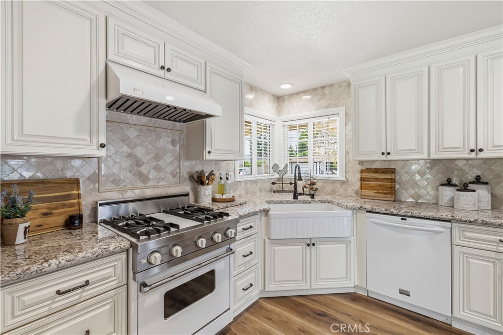 27816 Ridgegrove Drive Saugus, CA 91350 - Photo 7 of 65 a kitchen with granite countertop cabinets stainless steel appliances and a counter space