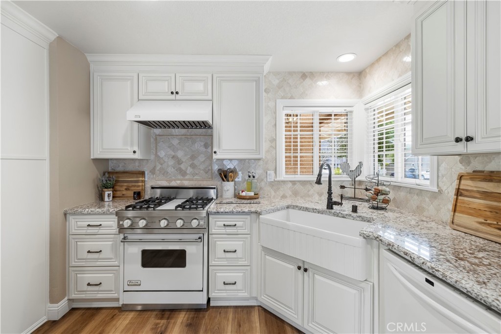 27816 Ridgegrove Drive Saugus, CA 91350 - Photo 9 of 65 a kitchen with granite countertop white cabinets and white appliances