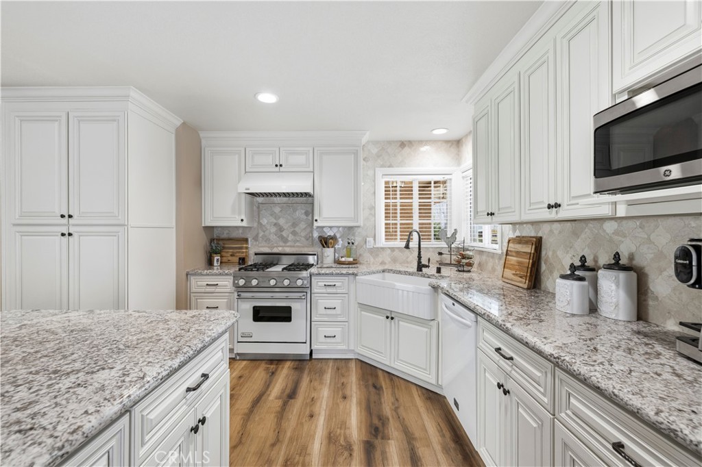 27816 Ridgegrove Drive Saugus, CA 91350 - Photo 10 of 65 a kitchen with sink stove top oven and microwave