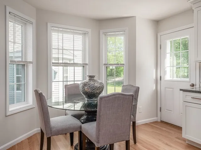 a view of a dining room with furniture a chandelier and wooden floor