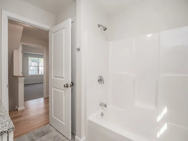 a bathroom with a bathtub and shower