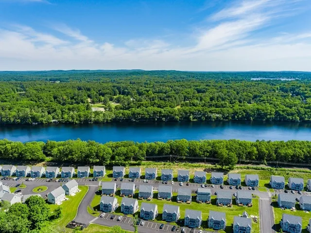 a view of a city with lawn chairs under an umbrella