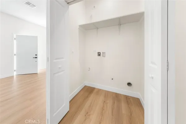 a view of a room with wooden floor