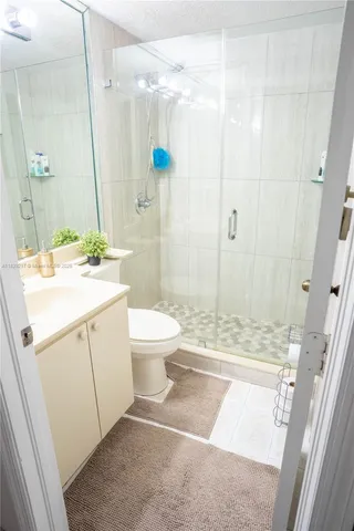 a bathroom with a sink toilet and shower