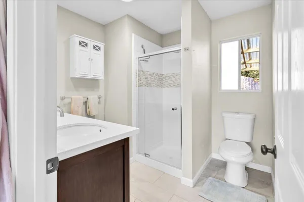 a bathroom with a sink a toilet and shower