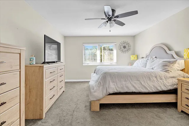 a bedroom with a bed and a dresser