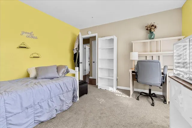 a bedroom with a bed and a chair