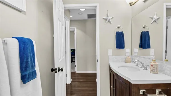 a bathroom with a sink vanity and a mirror