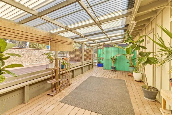 a view of a room with wooden floor