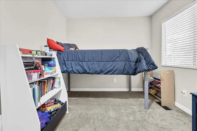 a living room with a book shelf and a shelf with bookshelf