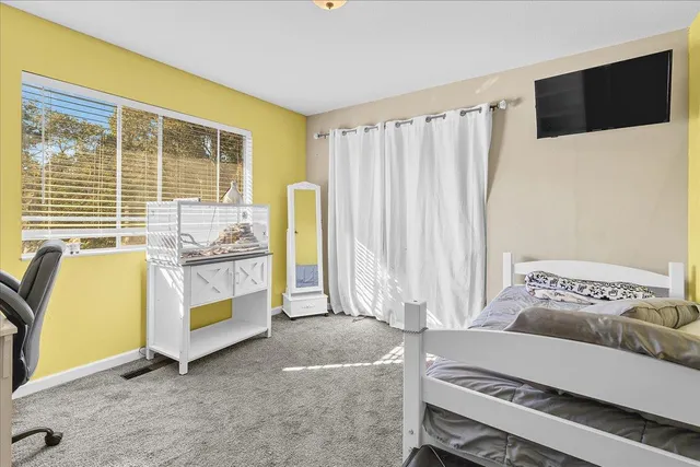 a bedroom with a bed and a window