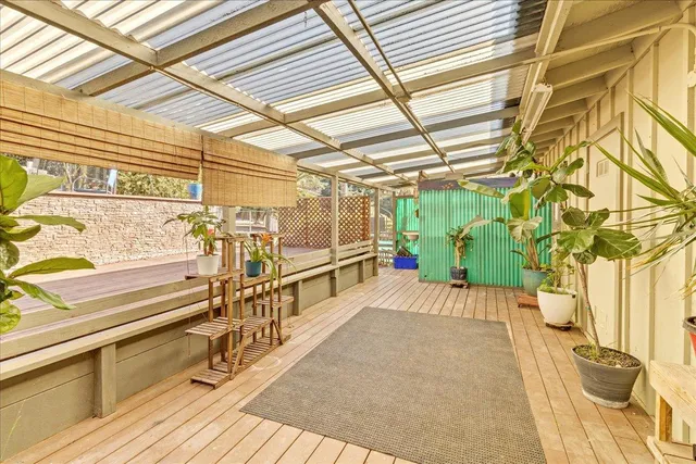 a view of a room with wooden floor