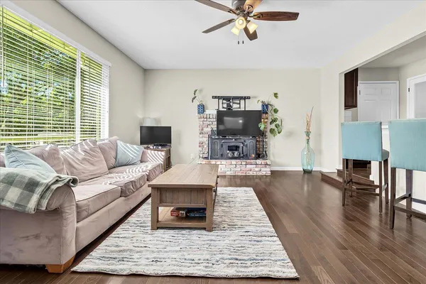 a living room with furniture and a wooden floor