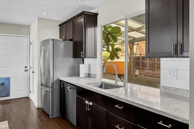 a kitchen with stainless steel appliances a sink and a refrigerator