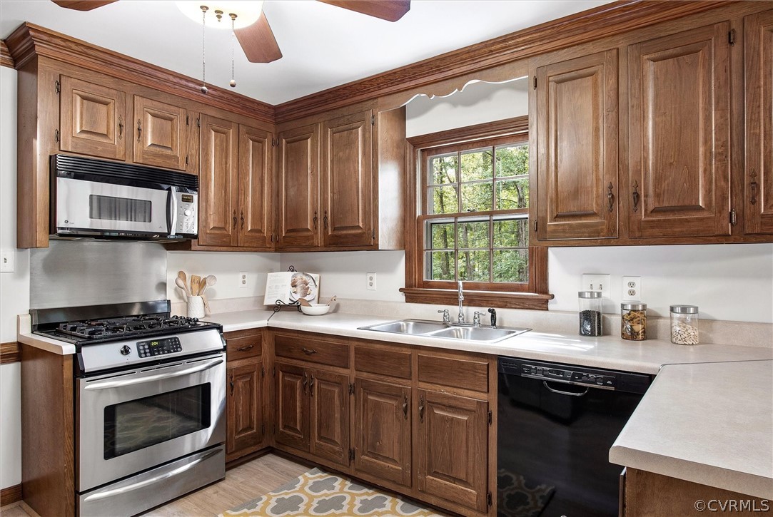 1006 Castle Hollow Road Midlothian, VA 23114 - Photo 14 of 42 a kitchen with stainless steel appliances granite countertop a sink stove microwave and cabinets