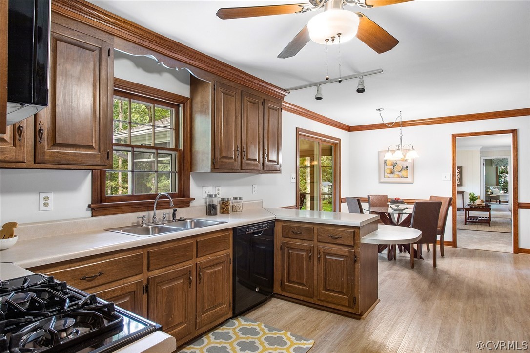 1006 Castle Hollow Road Midlothian, VA 23114 - Photo 16 of 42 a kitchen with a stove a sink dishwasher a dining table and chairs with wooden floor