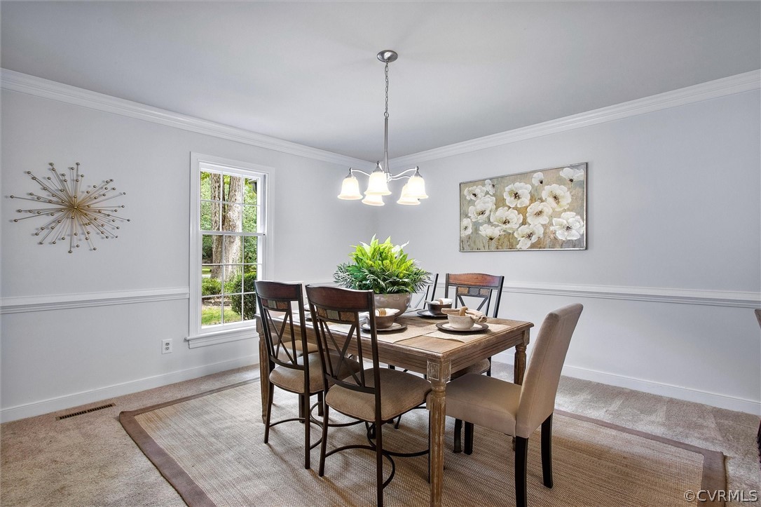 1006 Castle Hollow Road Midlothian, VA 23114 - Photo 17 of 42 a dining room with furniture a chandelier and window