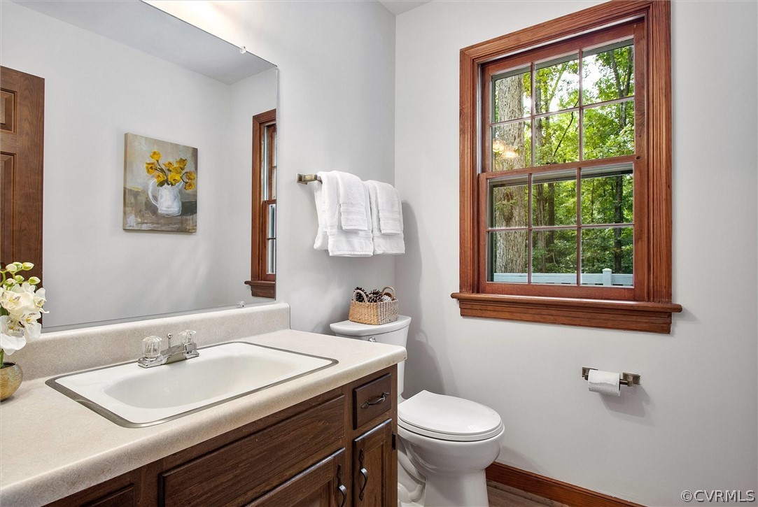1006 Castle Hollow Road Midlothian, VA 23114 - Photo 22 of 42 a bathroom with a granite countertop toilet a sink and a window