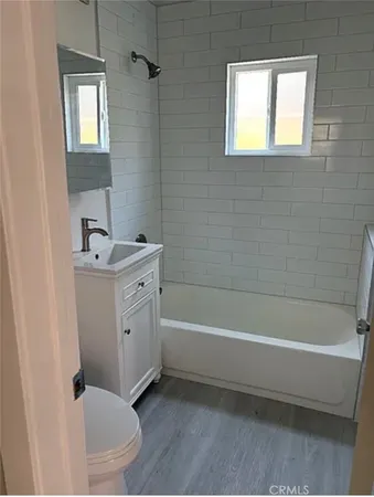 a bathroom with a bathtub sink and toilet
