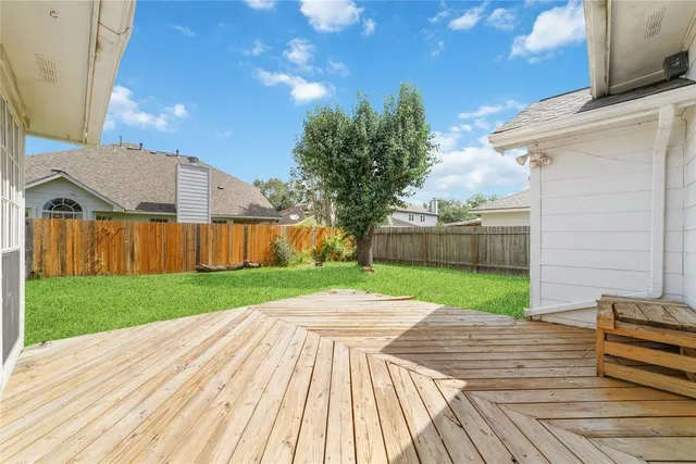 a view of a backyard with wooden fence