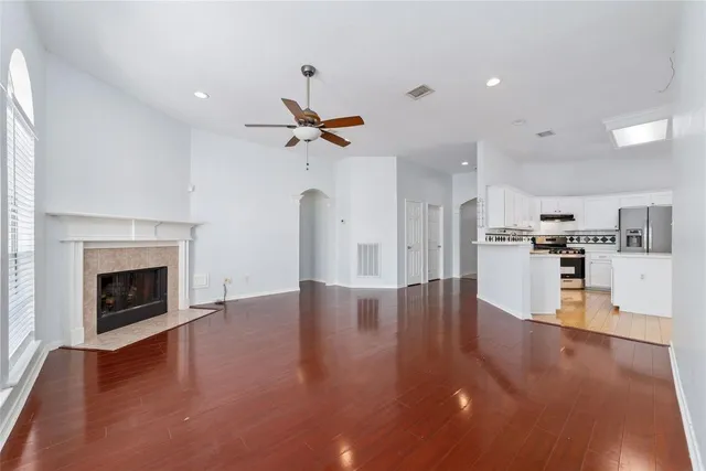 a view of a kitchen with a sink a refrigerator and a fireplace