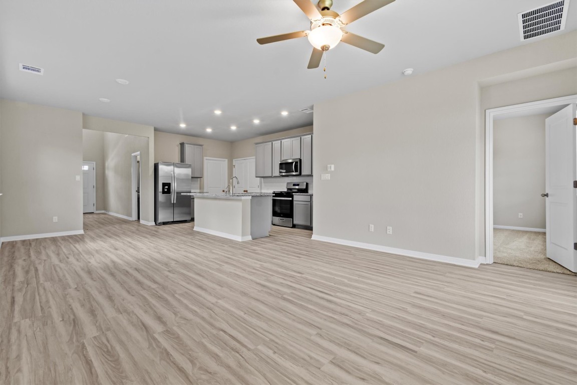 520 View Drive Georgetown, TX 78628 - Photo 3 of 23 a view of a kitchen with a sink and a refrigerator