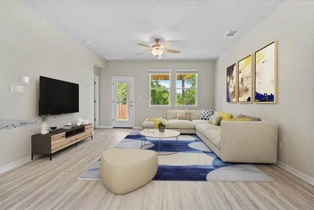a living room with furniture and a flat screen tv